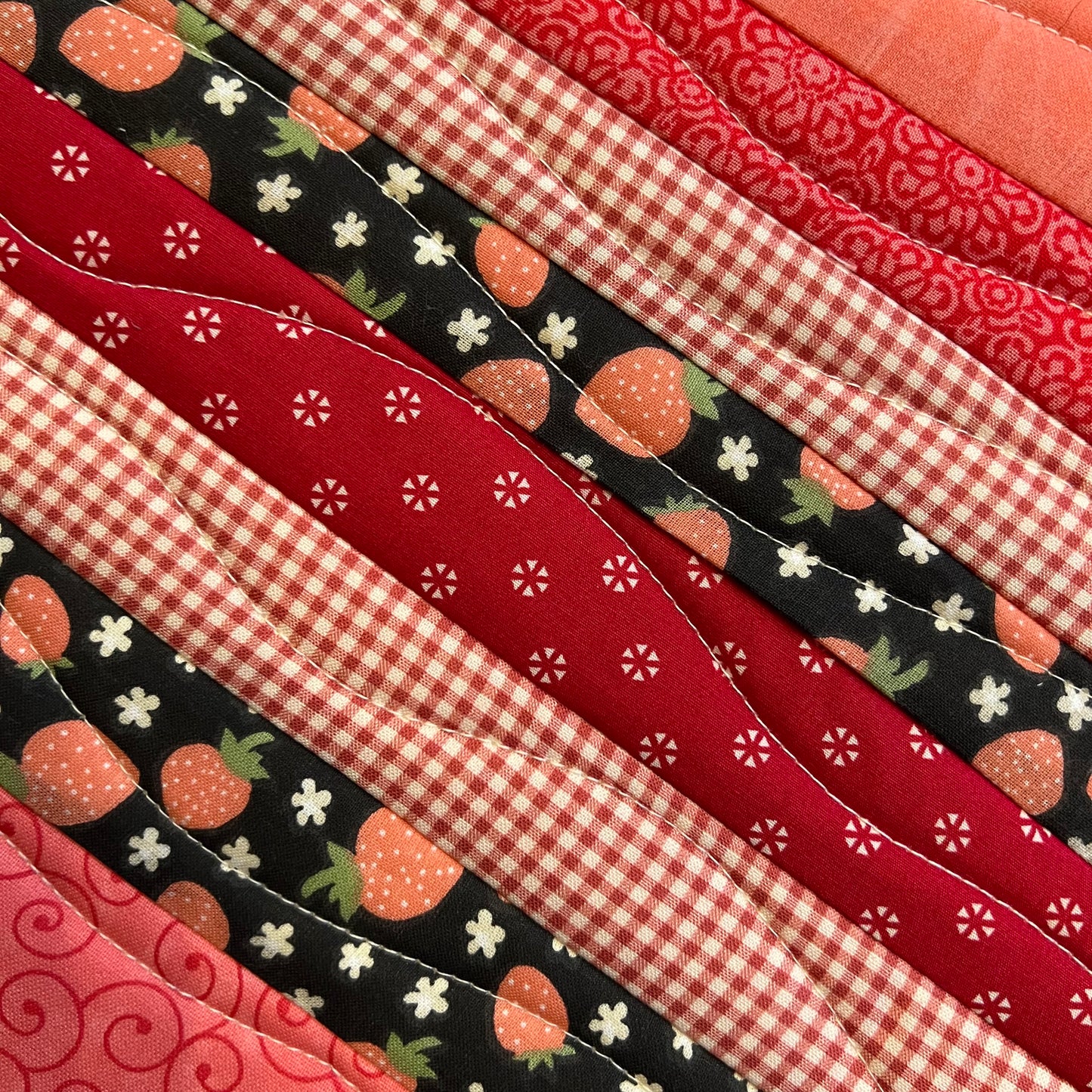 A closeup of the wavy quilt lines on the Eclectic Spruce Sweet Strawberry Hot Pad.