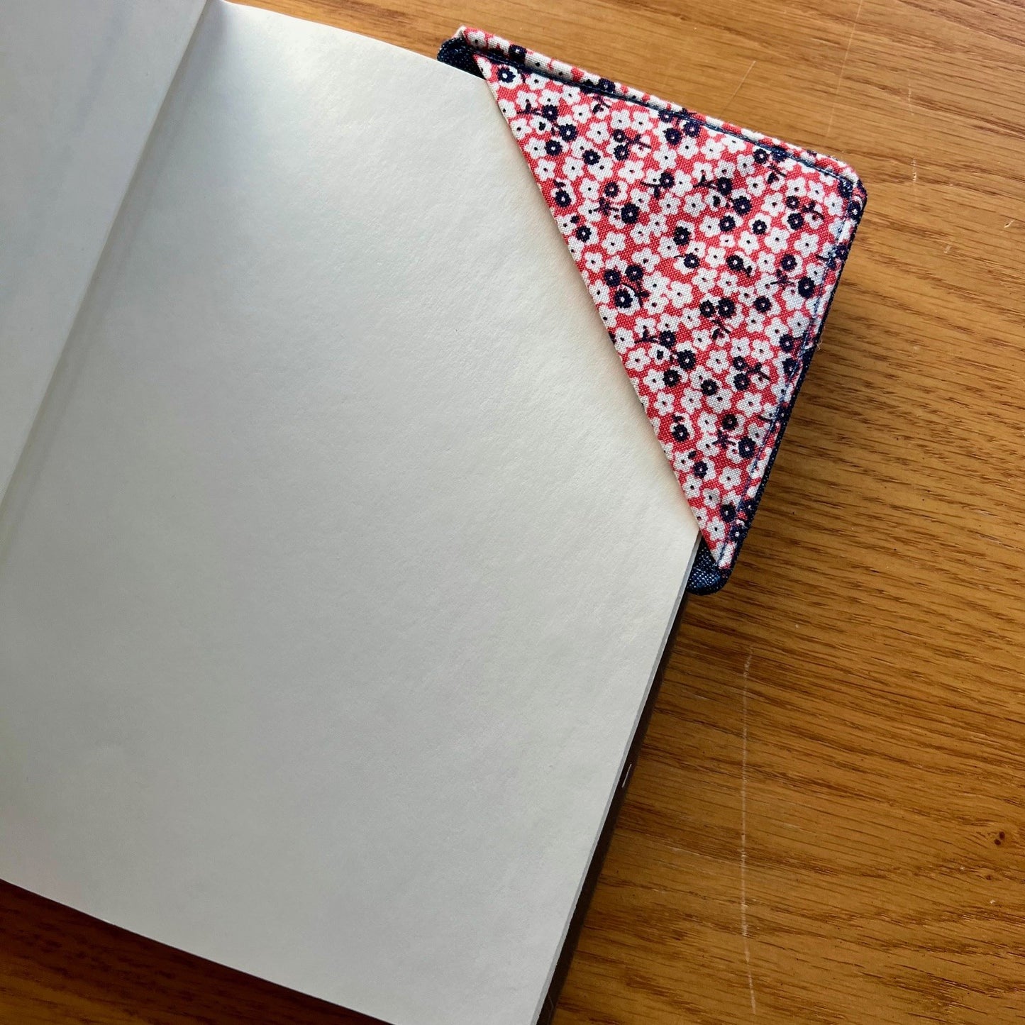 Eclectic Spruce corner bookmark placed inside of a book.