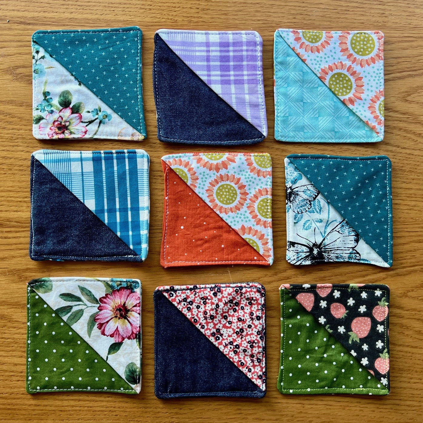 Several Eclectic Spruce Corner Bookmarks set on a wood surface, displaying a variety of colors, patterns, and textures.