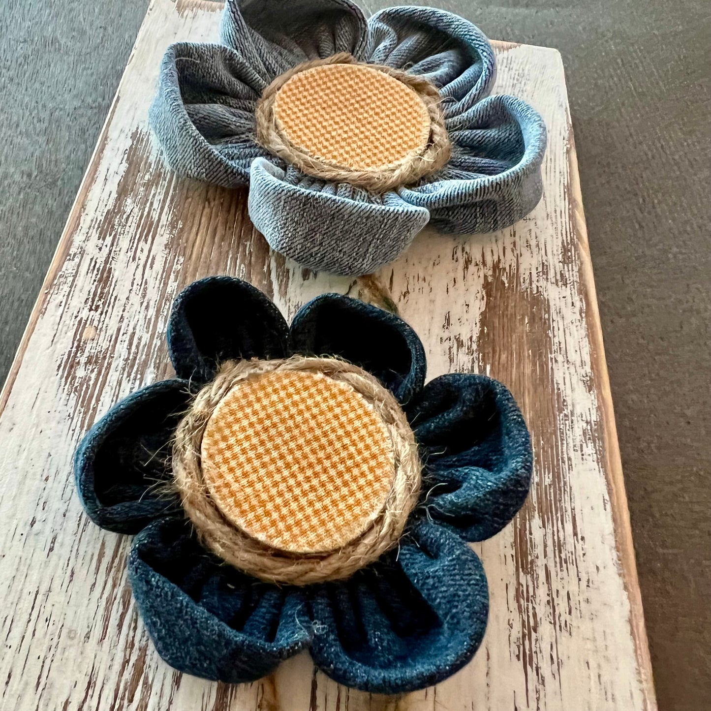 Close-up of the 3D botanical wall art featuring yellow gingham and reclaimed denim flowers on a white-washed wood plank.