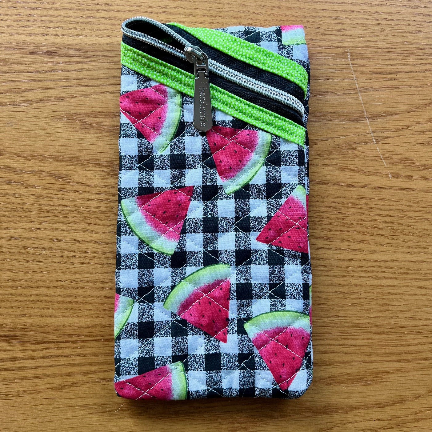 Quilted zipper pouch with portrait (vertical) oriented zipper opening.