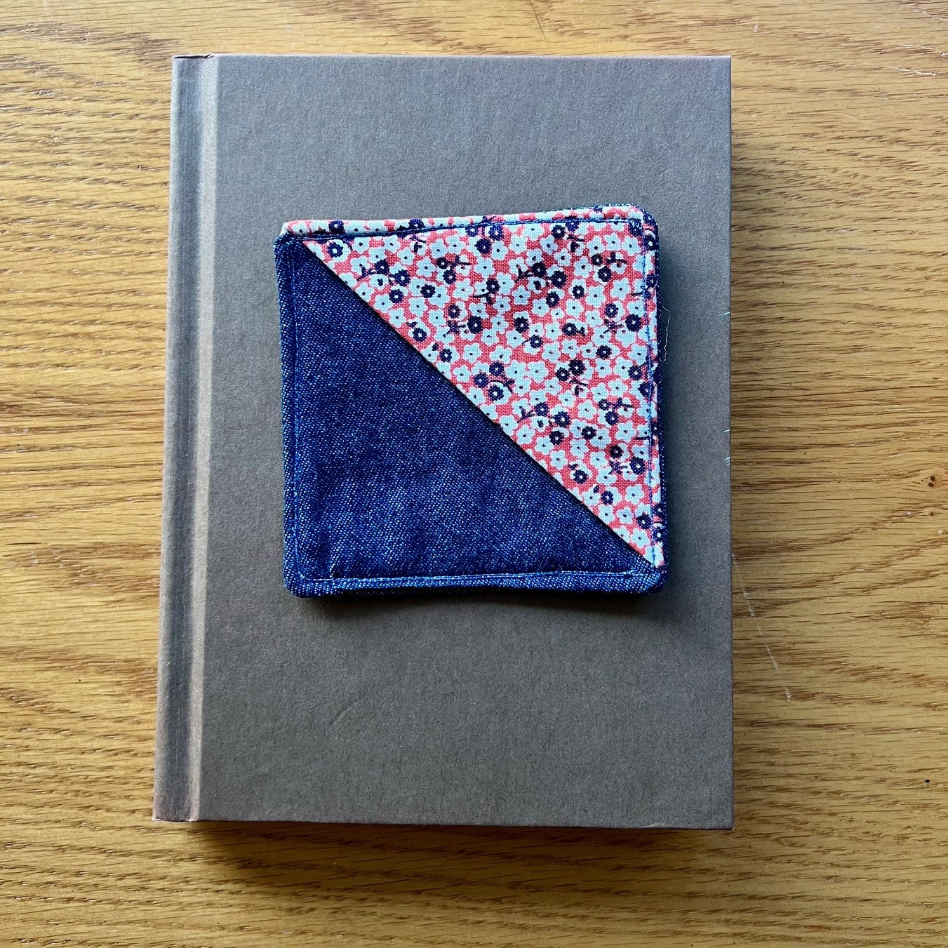 Eclectic Spruce corner bookmark sitting on top of a book.